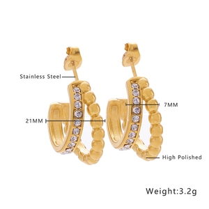 Macro view of 18k gold plated stainless steel C-shape hoops with zircon inlays