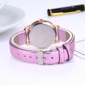 Detailed view of women's fashion watch with rose gold case and pink leather strap