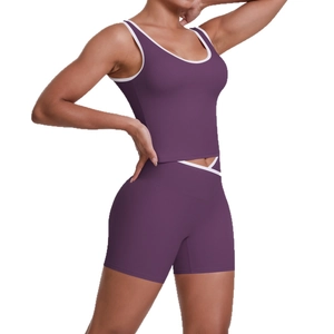 Purple two-piece yoga set with contrasting white trim and criss-cross waist sports shorts