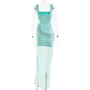 Detail view of light mint green dress showing ruched waist and sheer mesh fabric