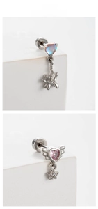 Macro detail of heart-shaped blue and pink stones with wing and dog charms