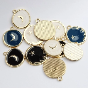 Star and moon enamel round pendants in black white and blue with gold plated alloy finish