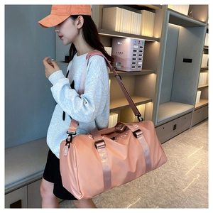 Pink waterproof cylinder gym bag with dual handles and adjustable shoulder strap