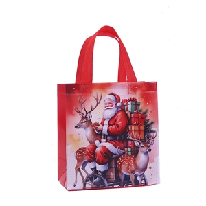 Christmas non-woven gift bag featuring Santa Claus on a sleigh with red handles