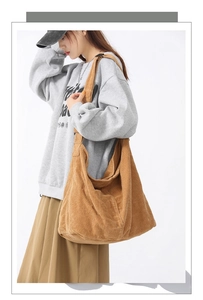 Brown corduroy tote bag shown on a model with grey sweatshirt and khaki long skirt