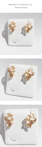 Detail view of handmade enamel Lily of the Valley earrings with pearls and crystals