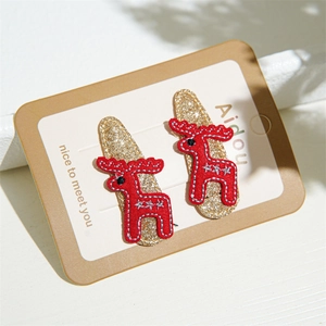 Close-up of cute Christmas reindeer hair clips with gold glitter and red felt embroidery