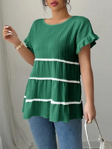 Elegant green tiered short sleeve blouse with white lace trim and pleated texture