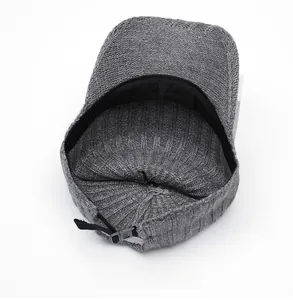Detail view of the internal knit structure and adjustable nylon strap of the gray cap