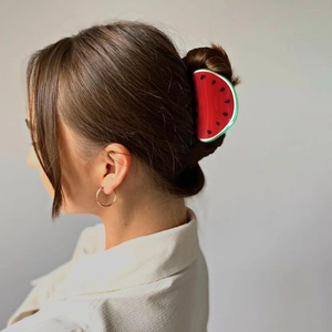 Watermelon fruit hair claw clip shown on a model for a stylish summer updo hairstyle