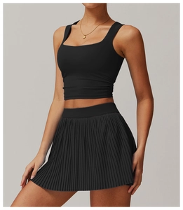 Close-up of black breathable square neck sports tank top and pleated athletic skirt