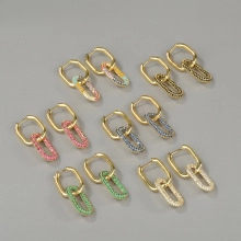 Macro shot of gold-plated earrings featuring vibrant pave-set colorful cubic zirconia crystals