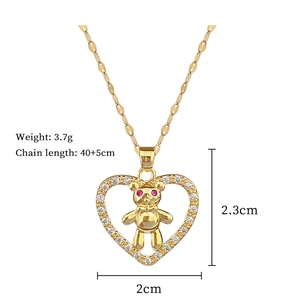Detail shot of gold teddy bear heart pendant showing 3.7g weight and 2.3cm height