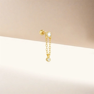 Macro shot of gold S925 sterling silver chain stud earring with zircon stones