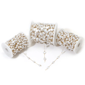 Detailed view of pearl bead chains with stars and circles on spools for DIY jewelry making