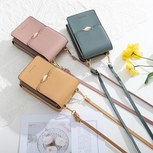 Detailed view of PU leather crossbody phone bags with gold leaf clasps in pink and green