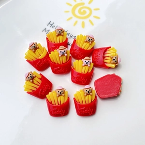 Flat lay of resin teddy bear and french fries charms for DIY phone case decoration