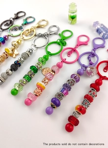 Detail of DIY painted colorful beads and metallic rings on handmade keychains