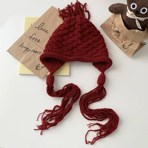 Chic dark red chunky knit beanie with long braided tassels and honeycomb texture