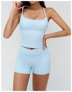 Detailed view of light blue yoga set showing racerback tank top and side pocket shorts