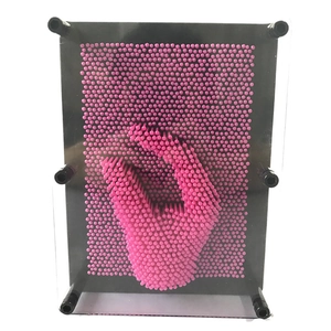 3D Pin Art toy in pink and black plastic frame showing hand impression sculpture