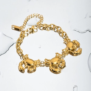 Gold titanium steel bracelet with three crab charms on a round link chain for women