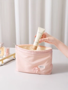 Pink plaid clover cosmetic bag with metal zipper and floral decor for travel storage