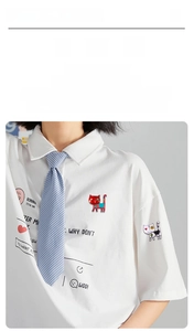 Close-up of adorable floral cat enamel pins worn on a white shirt pocket for decoration
