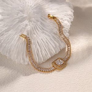 Elegant gold bracelet featuring square-cut emerald green and clear zircon gemstones