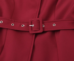 Close-up of burgundy blazer waist with matching fabric belt and silver metal eyelets