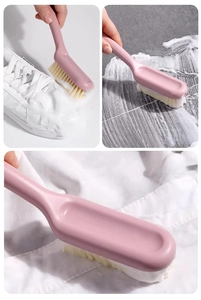 Macro detail of soft bristle brush cleaning shoes, floors, and clothes in pink color