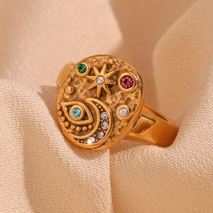 Macro detail of 18K gold plated ring featuring star moon patterns and colorful rhinestones