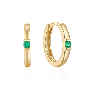 Detail of gold-plated silver hoops featuring a centered green round gemstone inlay