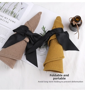 Foldable knitted sun hat with black bow detail shown in khaki and mustard colors