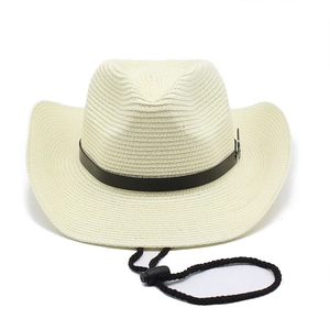 Detailed weave pattern of a beige straw cowboy hat with brown leather band and chin strap
