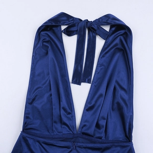 Detail of navy blue satin dress showing halter neck straps and deep V-neckline fabric texture