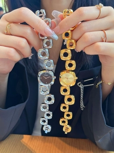Detail of elegant gold and silver bracelet watches with minimalist round hollow links