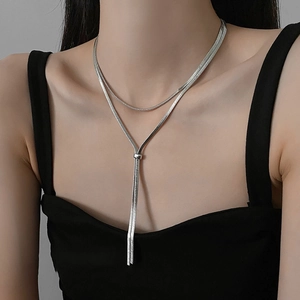 Minimalist silver-plated layered snake chain necklace with long tassel drop on a model