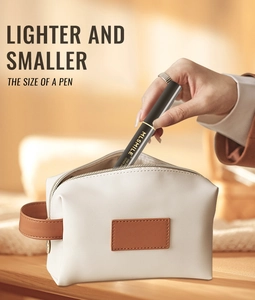 Lighter and smaller root touch-up gel pen being placed into a white cosmetic bag