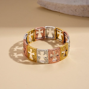Detailed view of hollow cross pattern on stretch metal bracelet with dot texture