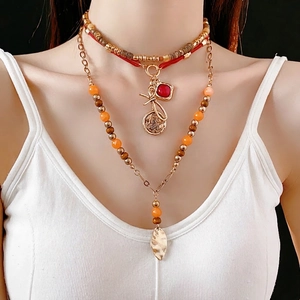 Bohemian multi-layer beaded necklace with vintage pendants and red gemstone charms