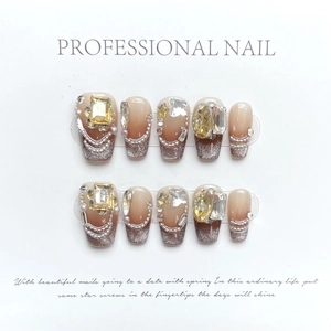 Detail of coffee ombre handmade press-on nails with silver glitter and 3D rhinestone