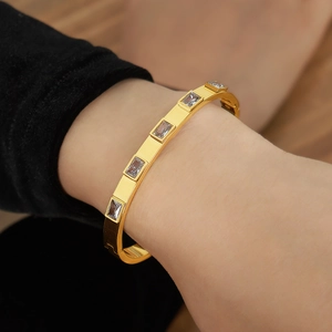 Elegant gold-plated stainless steel bangle with rectangular clear cubic zirconia stones