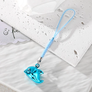 Cute blue dolphin phone charm with woven lanyard and bell on white textured background