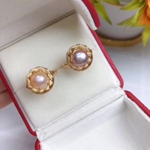 Elegant pair of freshwater pearl earrings in gold rope frame inside a gift box