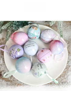 Detailed view of round tinplate wedding candy boxes with silk ribbons on a festive plate