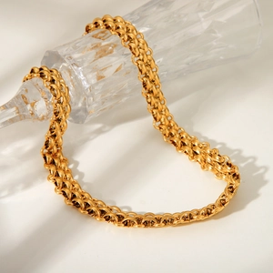 Elegant 18K gold-plated stainless steel woven chain necklace on a glass display