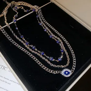 Three-layer silver Cuban chain necklace set with blue crystal evil eye pendants