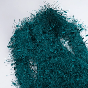 Detail shot of the dark green faux fur texture on a backless halter dress fabric