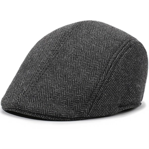 Detailed view of the dark grey herringbone fabric texture on this classic beret cap